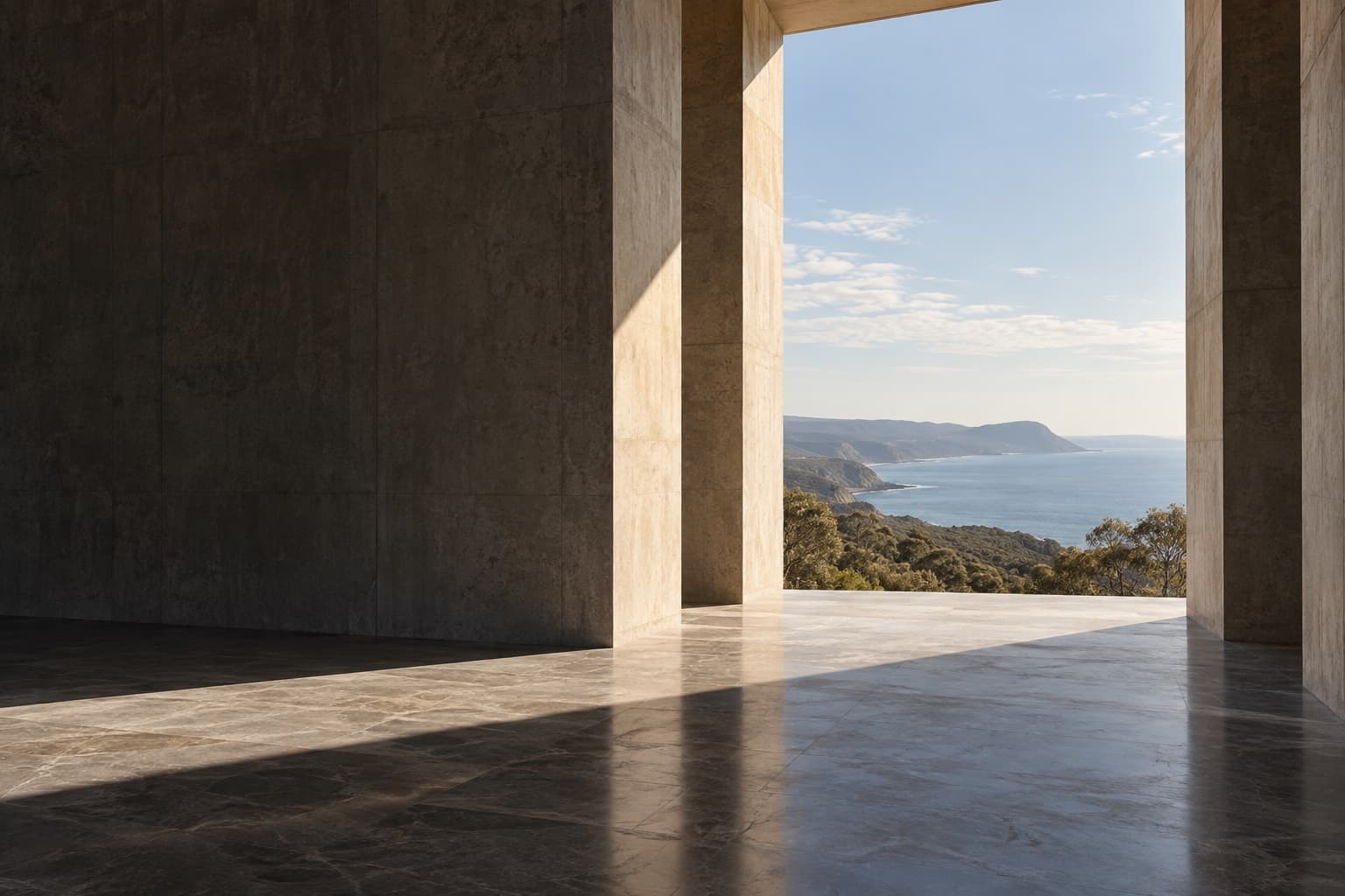A monumental architectural threshold opening towards a coastal landscape
